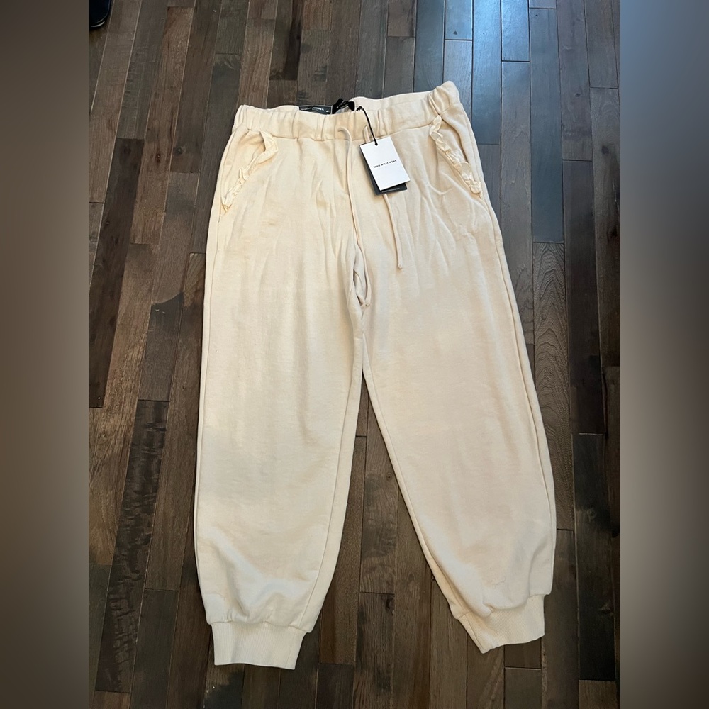 Who What Wear mid waist joggers with ruffle pocket trim.